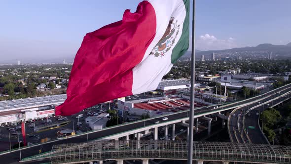 upwards drone shot of mexico national flag during windy day