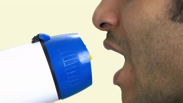 Close Up View of Man Talking Into Megaphone.