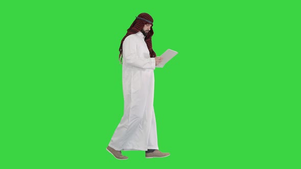 Sheikh Using Digital Tablet and Walking on a Green Screen, Chroma Key.