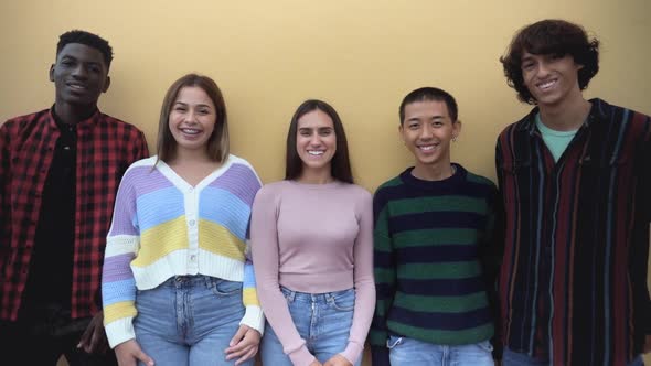 Happy multiracial group of teenagers having fun outside school - Young people lifestyle concept