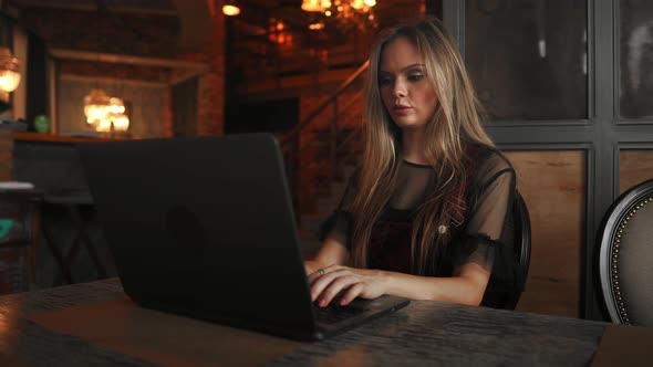 Beautiful Young College Student on a Cafe.