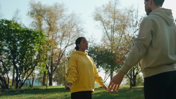 Man and Woman Doing Breathing Exercises at the Park in the Autumn Morning