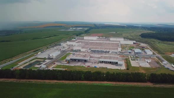 Aerial view of warehouse with trucks. Industrial background. Logistics from above