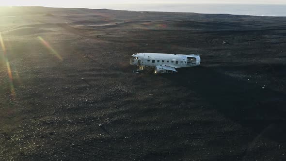 Drone Over Plane Wreckage In Black Sand