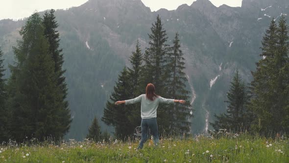 Slow Motion Shot of Happy Young Woman Spinning and Running in the Dolomites Northern Italy in the