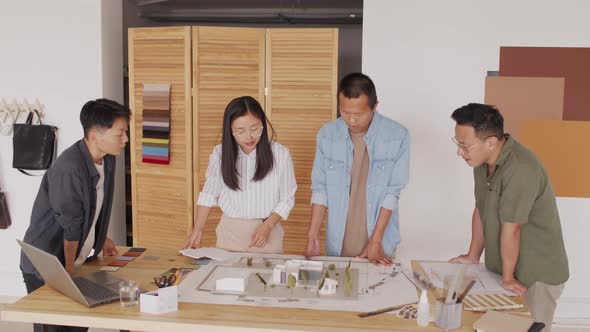 Team of Asian Architects Looking at House Layout