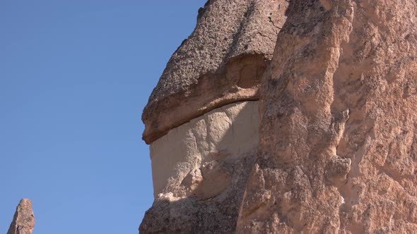 Close Up of Huge Stone Formation on Blue Sky Background.