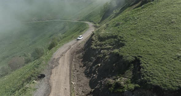 AERIAL - Car driving down the Tskhratskaro Pass, Georgia, forward shot