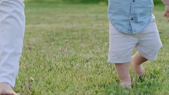 Curious Toddler Walking Barefoot on Grass alt