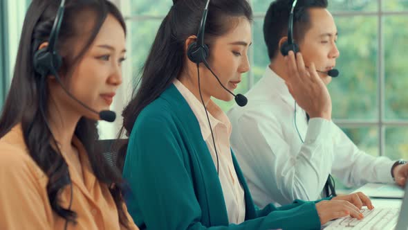 Business People Wearing Headset Working Actively in Office