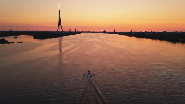 Following After Small Boat Sailing Along River Daugava in the Evening