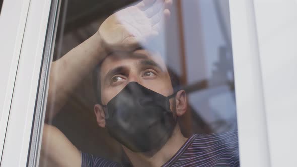 Man in Protective Mask Behind the the Window on Quarantine