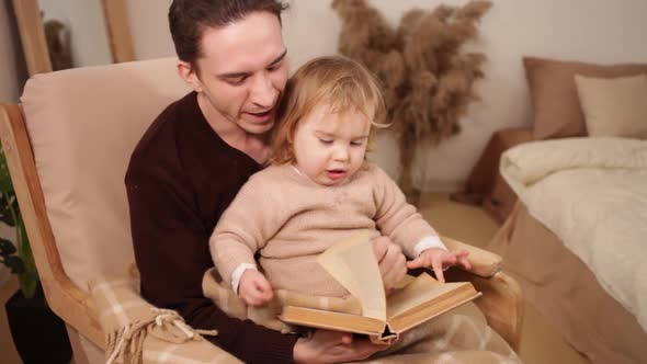 Father and Daughter Read a Book Have Fun Laugh