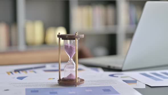 Close Up of Hourglass on Businessman Office Desk