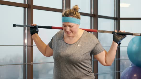 Woman with Excess Weight Workout Tirelessly at a Gym