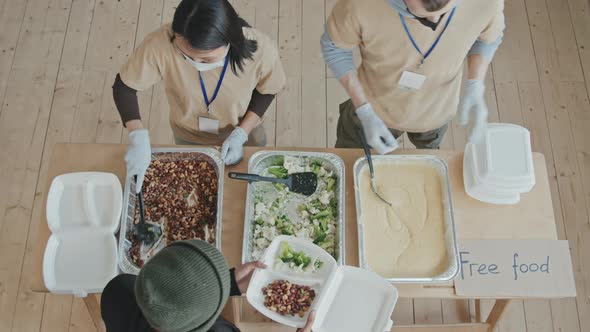 Top-View of Volunteers Giving Food to Needy People