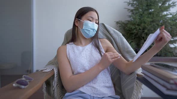 Young Beautiful Asian Woman in Covid19 Face Mask Showing Thumb Up Discussing Business Strategy