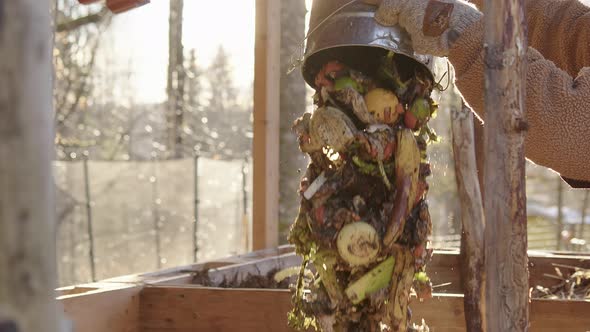 SLOW MOTION CLOSEUP, stunning shot of food waste bucket being emptied