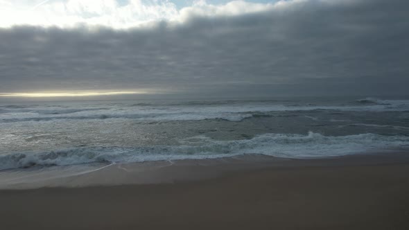 Ocean Waves Splash Into Sandy Beach