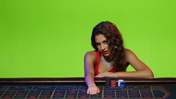 Beautiful Girl Sitting at the Poker Table in a Casino