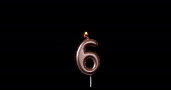 Realistic full-sized single birthday candlelight 6 six number isolated on black background. 