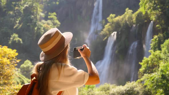 Joyful Young Woman Tourist with Camera Makes Photos for Social Media Network