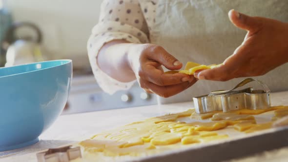 Senior woman preparing cookies in kitchen at home 4k