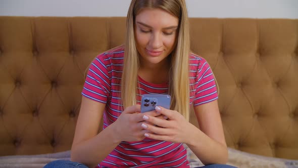 Happy young female using modern mobile phone app with cheerful smile in 4k footage