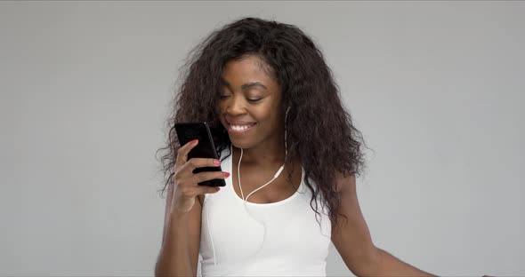 Black Woman Listening To Music and Smiling