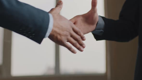 Close Up Male Hands Multiethnic Business Men African and Caucasian Colleagues in Suit Handshake in