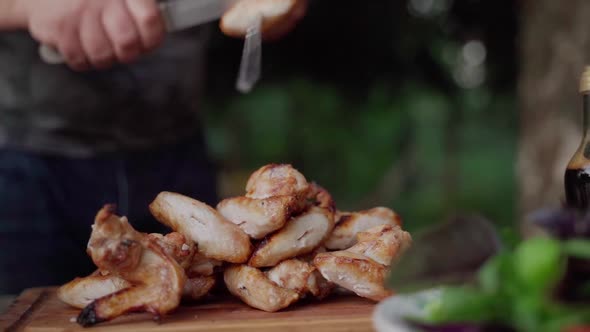 Chief Removes Grilled Chicken Wings From the Skewers