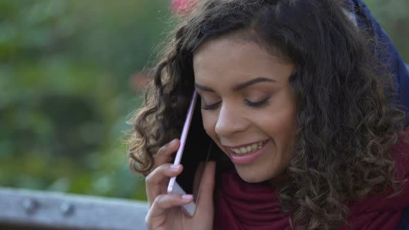 Happy Mixed Race Woman Talking Over Smartphone Outdoors, Smiling, Ending Call