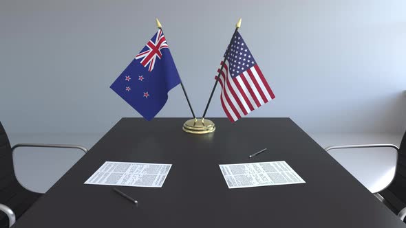 Flags of New Zealand and the United States on the Table