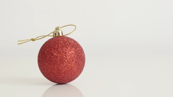 Shiny red bauble with sequins close-up 4K 2160p 30fps UltraHD tilting  footage - Christmas ornament 