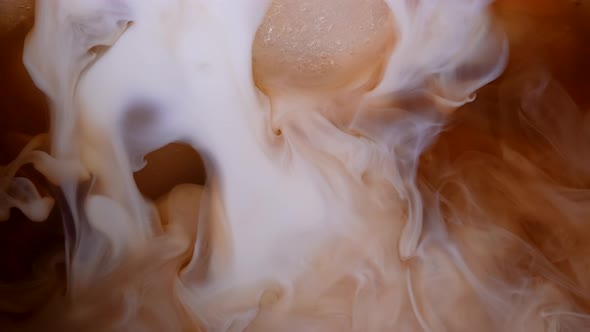 Pouring Milk or Cream Into an Icy Coffee Drink in Slow Motion