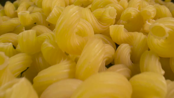 Close-up traveling across a bunch of tortiglioni pasta.