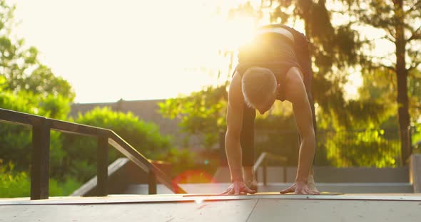 Muscular Man in Morning Light Doing Handstand Moving Legs Up and Down