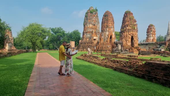 Ayutthaya Thailand at Wat Mahathat Couple Men and Women with a Hat and Tourist Map Visiting