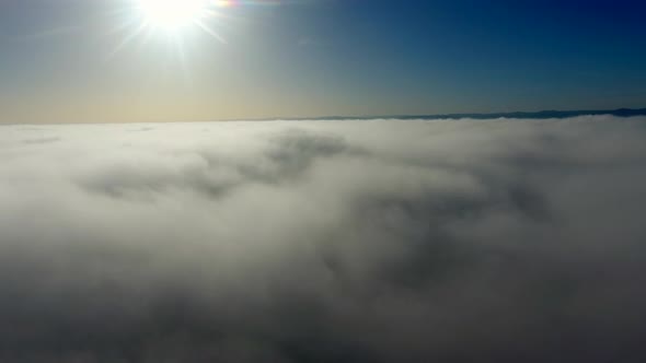 Aerial View, Flying Through Clouds at Sunset