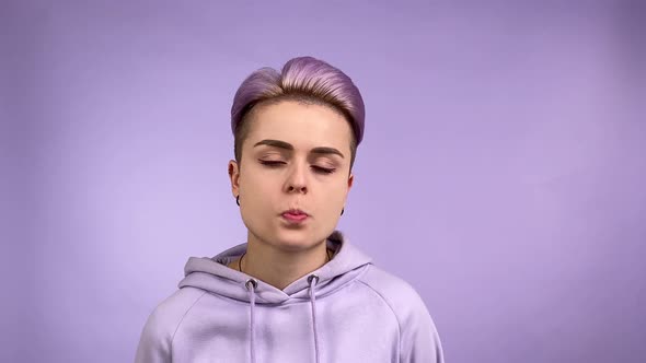 Young Woman in Purple Chewing Gum Indifferent Look Blowing Bubble