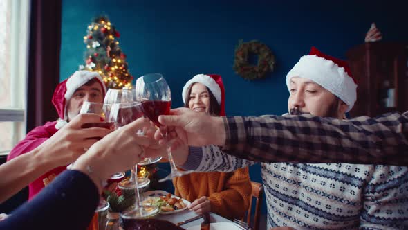 Multiracial Young Men and Women in Warm Jumpers and Sweaters Clink Glasses of Wine Happy American