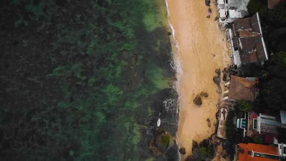 Beautiful Bingin beach with exotic cliffs houses and hotel located in Bali, Indonesia. This drone fo