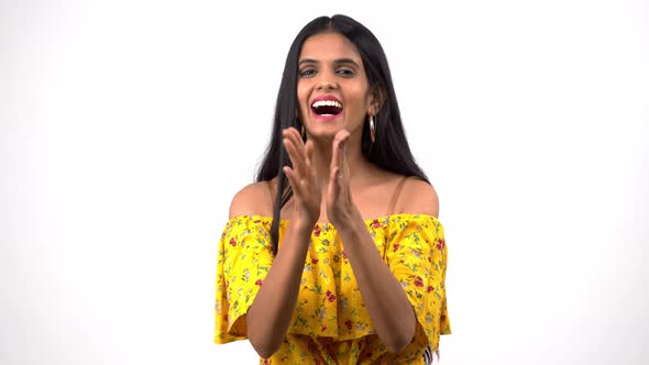 Happy Indian girl clapping and smiling