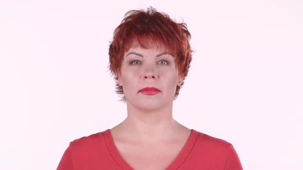 Redhaired Woman Looks Into the Distance and Smiles. White Background