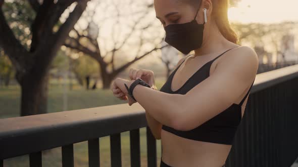 Woman setting up the fitness smart watch for running. Sportswoman checking watch device.