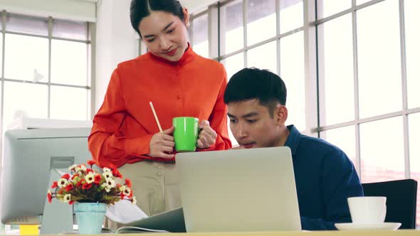 Two Business People Talk Project Strategy at Office