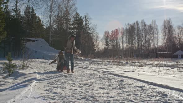 Woman and Boy Sledding in Winter