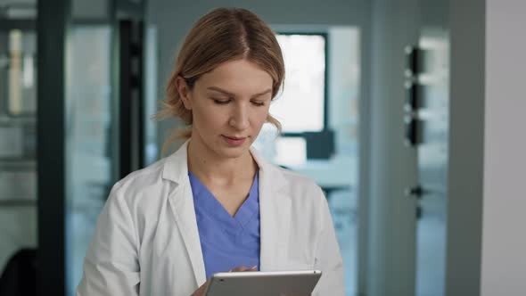 Caucasian female doctor using digital tablet in medical clinic. Shot with RED helium camera in 8K.