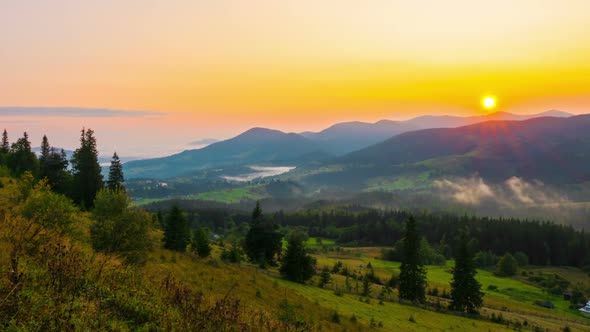 Fantastic Sunrise over the Foggy Summer Mountain