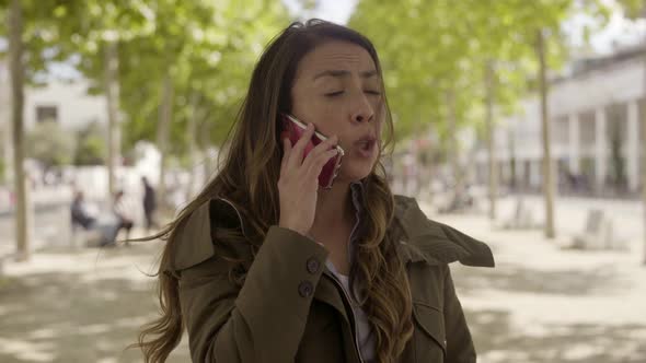 Angry Young Businesswoman Talking on Phone Outdoor